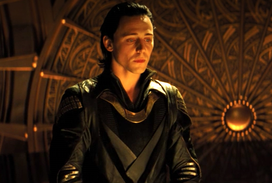 Loki looking pensive, his costume with ornate curves and interweaving designs