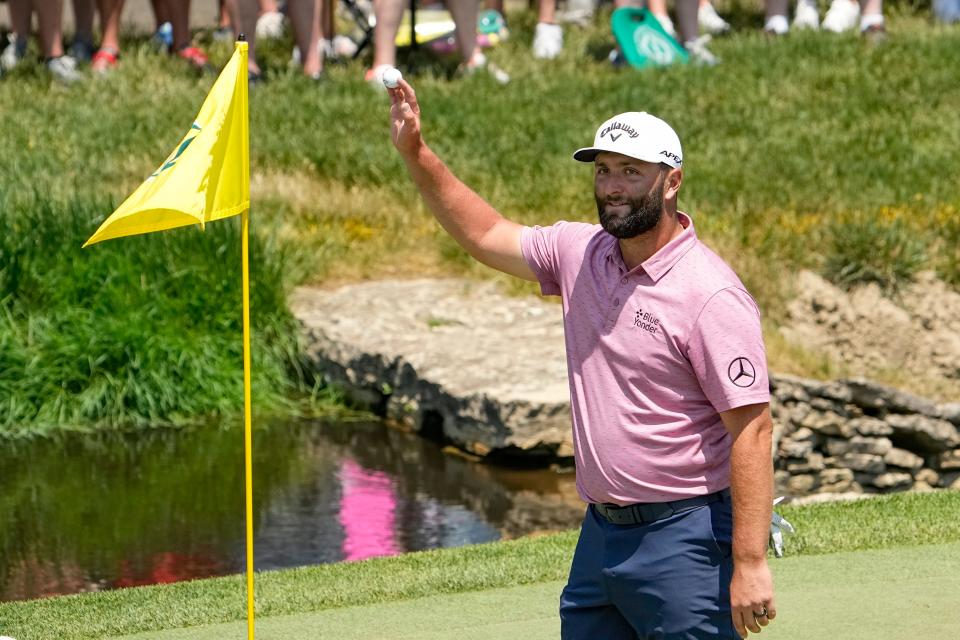 June 4, 2023; Dublin, Ohio, USA;  Jon Rahm waves to the crowd as he celebrates an eagle from the ninth fairway while walking onto the green during the final round of the Memorial Tournament at Muirfield Village Golf Club. 