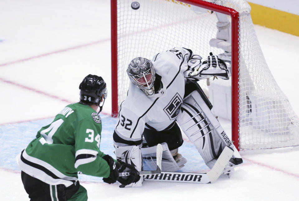 Dallas Stars right wing Denis Gurianov (34) scores on Los Angeles Kings goaltender Jonathan Quick (32) in overtime in an NHL hockey game Friday, Oct. 22, 2021, in Dallas. (AP Photo/Richard W. Rodriguez)