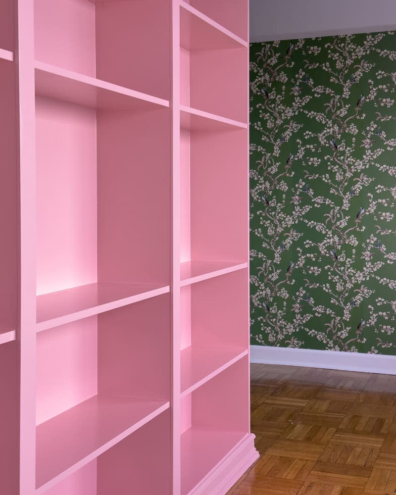 Pink painted bookshelf.