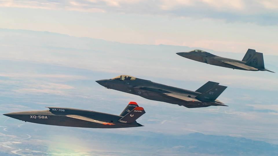 A Kratos XQ-58 Valkyrie drone, at bottom left, flies together with an F-35A Joint Strike Fighter, at center, and an F-22 Raptor stealth fighter, at top right. Air Force XQ-58s have been supporting advanced autonomy work and other projects since the type's first flight in 2019. The stealthy Valkyrie is often held out as a practical example of an attritable design. <em>USAF</em>