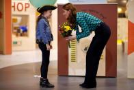 <p>The Duchess of Cambridge plays with a child as she visits MiniBrum, an interactive, child-sized world at Thinktank at Birmingham Science Museum. She chevron pussy-bow blouse by Tabitha Webb. </p>