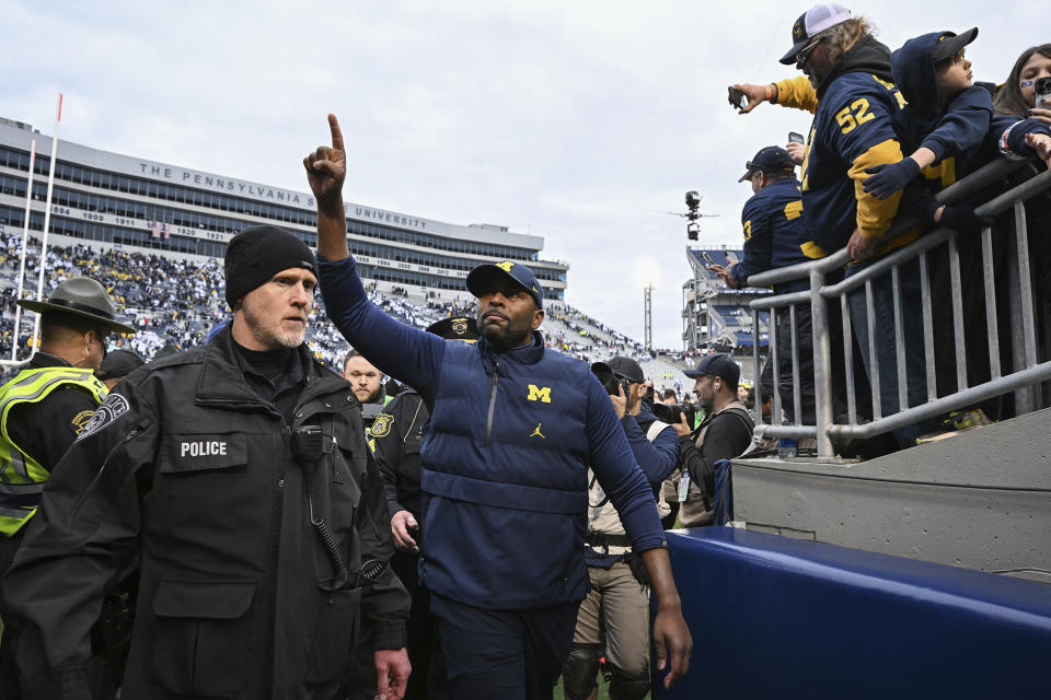 Michigan acting head coach Sherrone Moore celebrates a 24-15 win over Penn State following an NCAA college football game, Saturday, Nov. 11, 2023, in State College, Pa. (AP Photo/Barry Reeger)