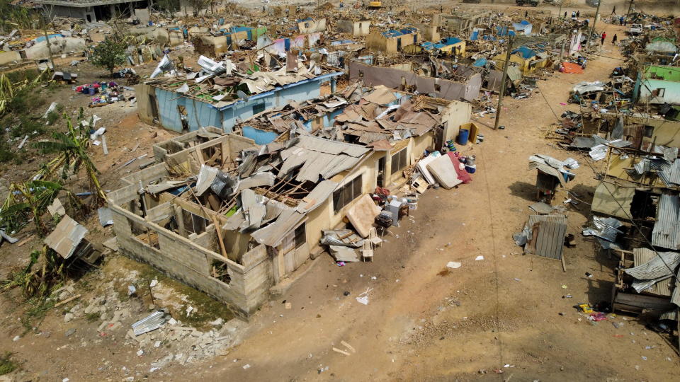 Debris of houses and other buildings destroyed when a vehicle carrying mining explosives detonated after a collision along a road in Apiate, Ghana, January 21, 2022. / Credit: COOPER INVEEN/REUTERS