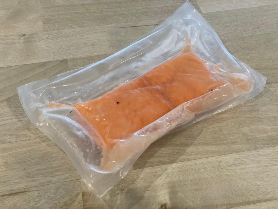 vacuum sealed pack of salmon on a table