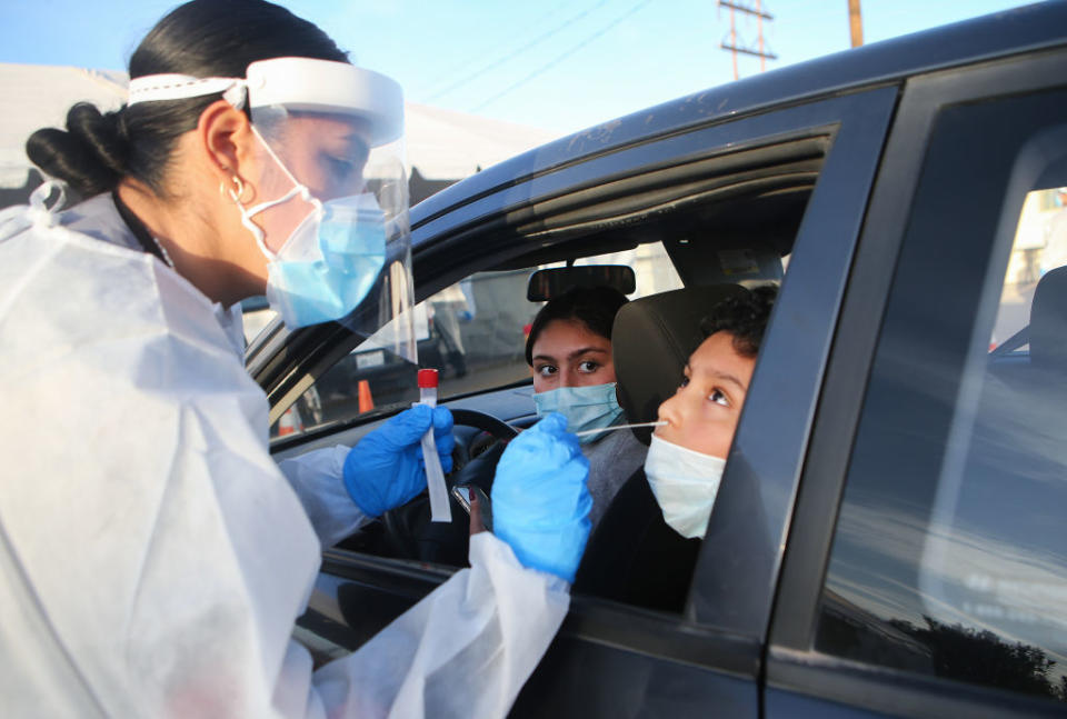 Frontline healthcare worker Joanne Grajeda administers a nasal swab test at a drive-in COVID-19 testing site in Texas. Source: Getty