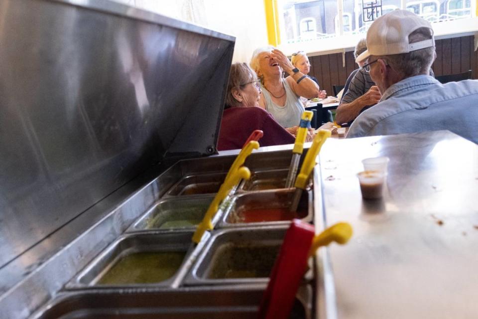 Linda Medoff laughs as she and her husband Richard Milford enjoy tacos with friends Donna and Richard Myers at California Taco Shop on Wednesday in Kansas City, Kansas.