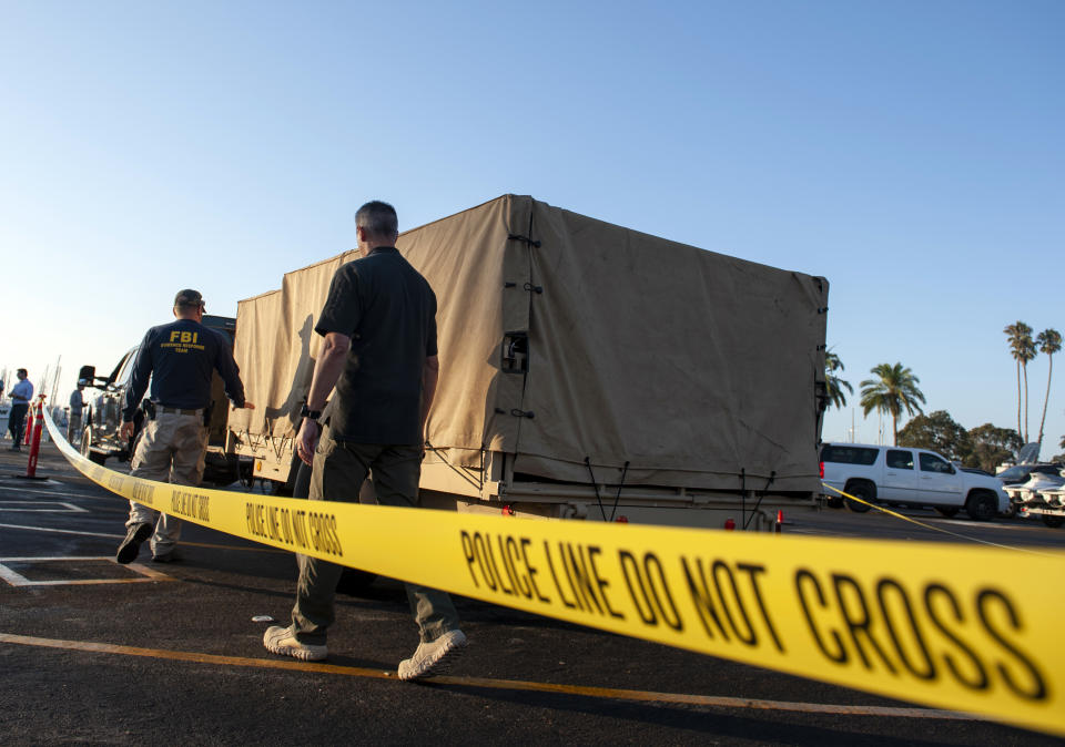 FBI investigators unload equipment to begin examining evidence obtained from the wreckage of the dive boat Conception on Wednesday, Sept. 4, 2019, in Santa Barbara, Calif. A fire raged through the boat carrying recreational scuba divers anchored near an island off the Southern California Coast on Monday, Sept. 2, leaving multiple people dead. (AP Photo/Christian Monterrosa)
