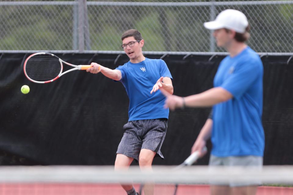 Washburn Rural's Nick Luetje returns the ball while playing in a doubles match with partner Kyler Knudtson against Junction City during Friday's 6A regionals at Kossover Tennis Complex.