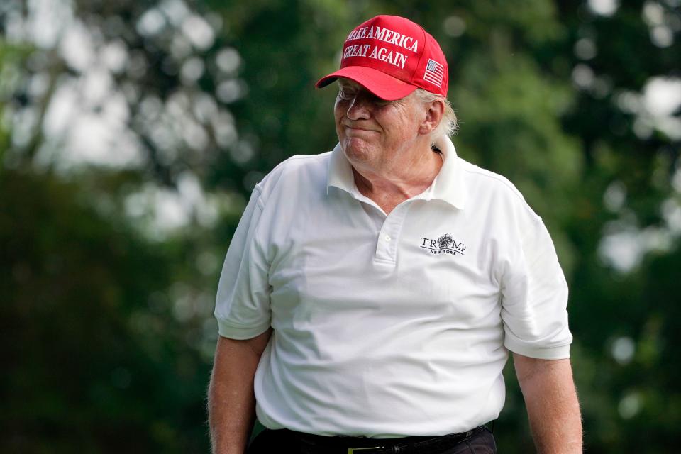 Former President Donald Trump reacts to his tee shot on the fourth hole during the pro-am round of the Bedminster Invitational LIV Golf tournament.