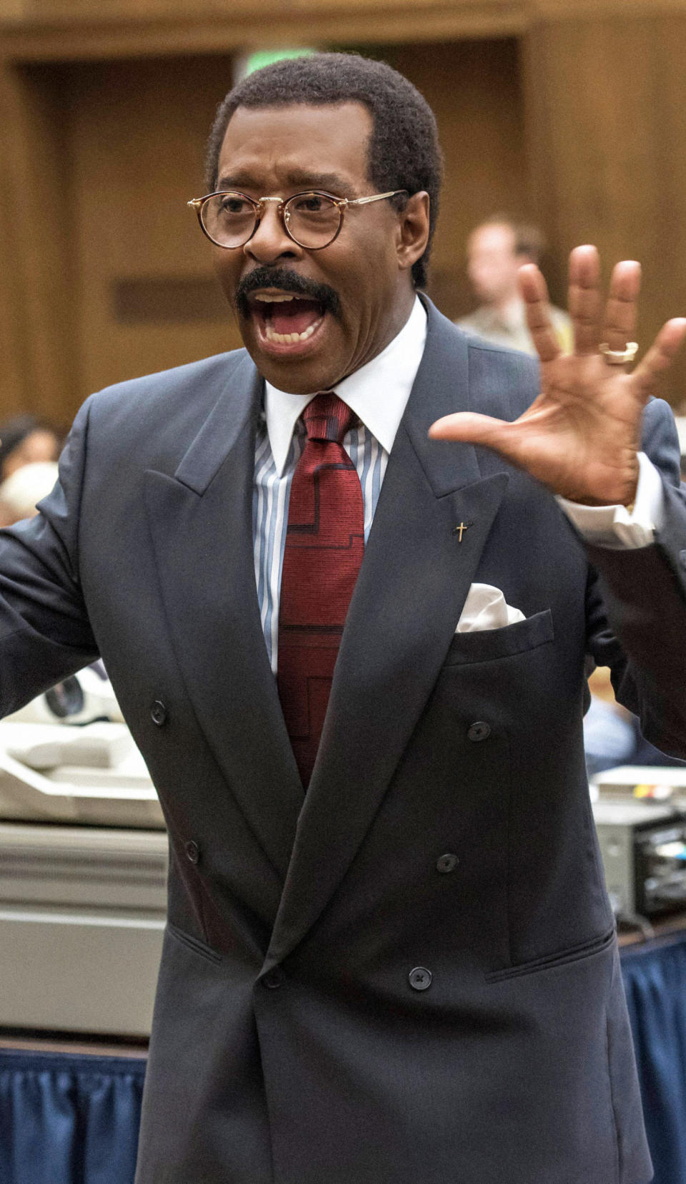 Vance wearing Cochran's infamous glasses and suit; Putting his hands up in court