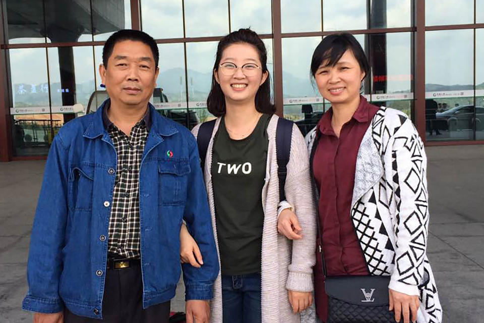 FILE - This 2017 file photo provided by Xinyang Zhang shows his sister, Yingying, with their parents, Ronggao Zhang, right, and Lifeng Ye, at a train station in Nanping, China. The 26-year-old visiting scholar at the University of Illinois at Urbana-Champaign, disappeared June 9, 2017. Brendt Christensen, a former graduate student, has been charged with kidnapping and killing her. Zhang's body has not been found. (Xinyang Zhang via AP, File)