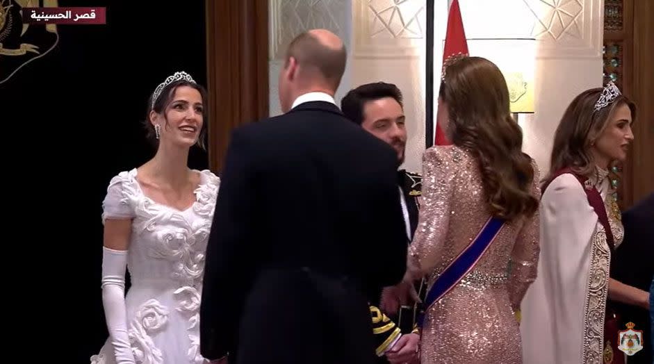 The royal couple talking to the bride and groom