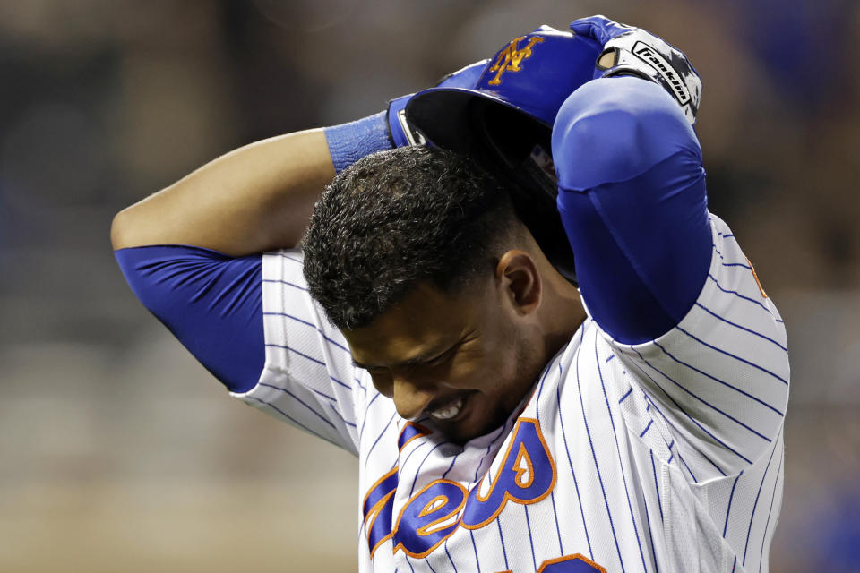 New York Mets' Eduardo Escobar reacts to flying out during the ninth inning of the team's baseball game against the Chicago Cubs on Wednesday, Sept. 14, 2022, in New York. The Cubs won 6-3. (AP Photo/Adam Hunger)