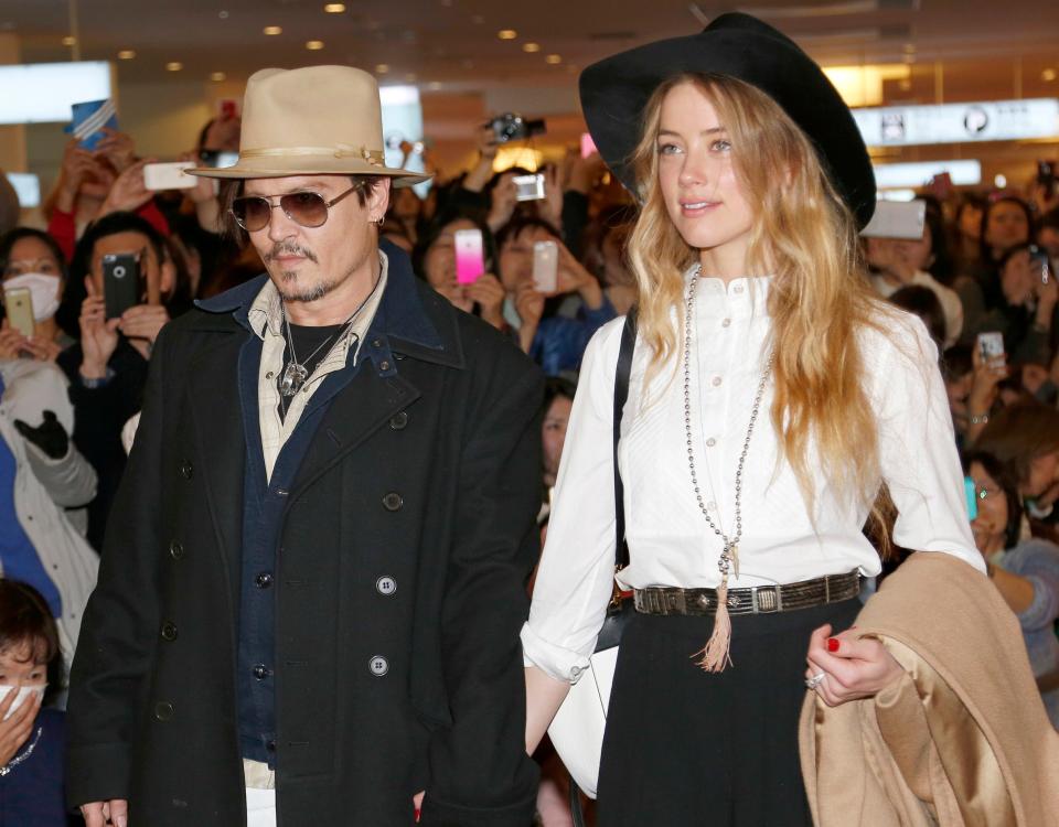 In this Jan. 26, 2015 file photo, Johnny Depp and Amber Heard arrive at Haneda international airport in Tokyo to promote his latest film "Mortdecai."