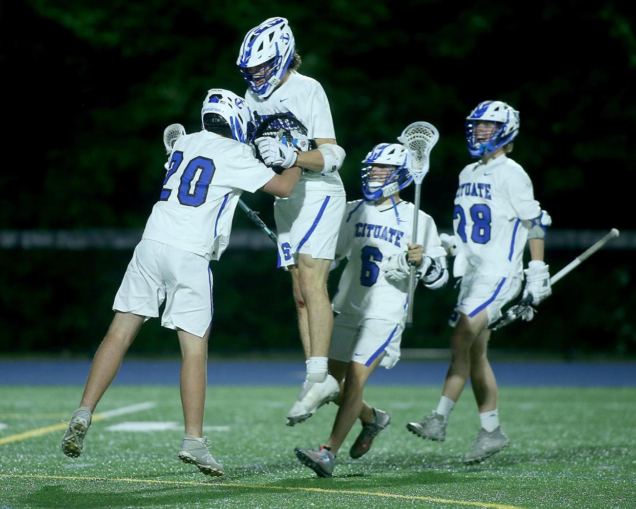 Scituate's Lawson Foley jumps in the arms of Scituate goalie Lydon O'Brien following their 18-3 win over Whitman-Hanson in the Round of 32 of the Division 2 state tournament at Scituate High School on Tuesday, June 7, 2022. 