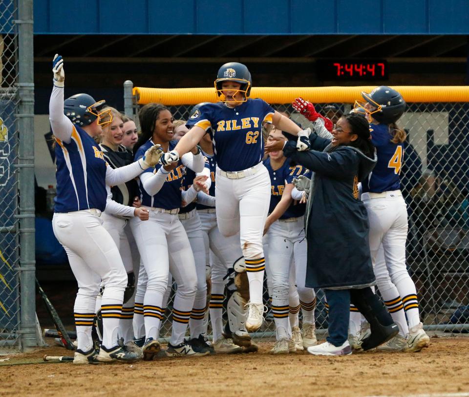 Riley sophomore Elliana Gonzales (62) celebrates with her teammates after hitting a home run during a softball game against Adams Wednesday, April 17, 2024, at Riley High School in South Bend.