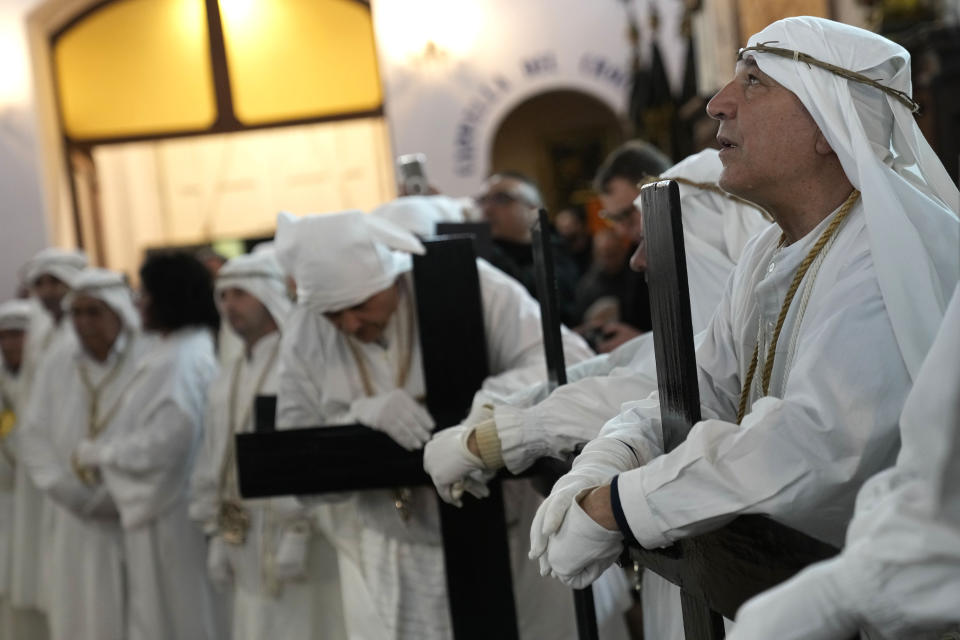 Members of a confraternity pray during a Holy Thursday procession the in Procida Island, Italy, Thursday, March 28, 2024. Italy is known for the religious processions that take over towns big and small when Catholic feast days are celebrated throughout the year. But even in a country where public displays of popular piety are a centuries-old tradition, Procida's Holy Week commemorations stand out. (AP Photo/Alessandra Tarantino)