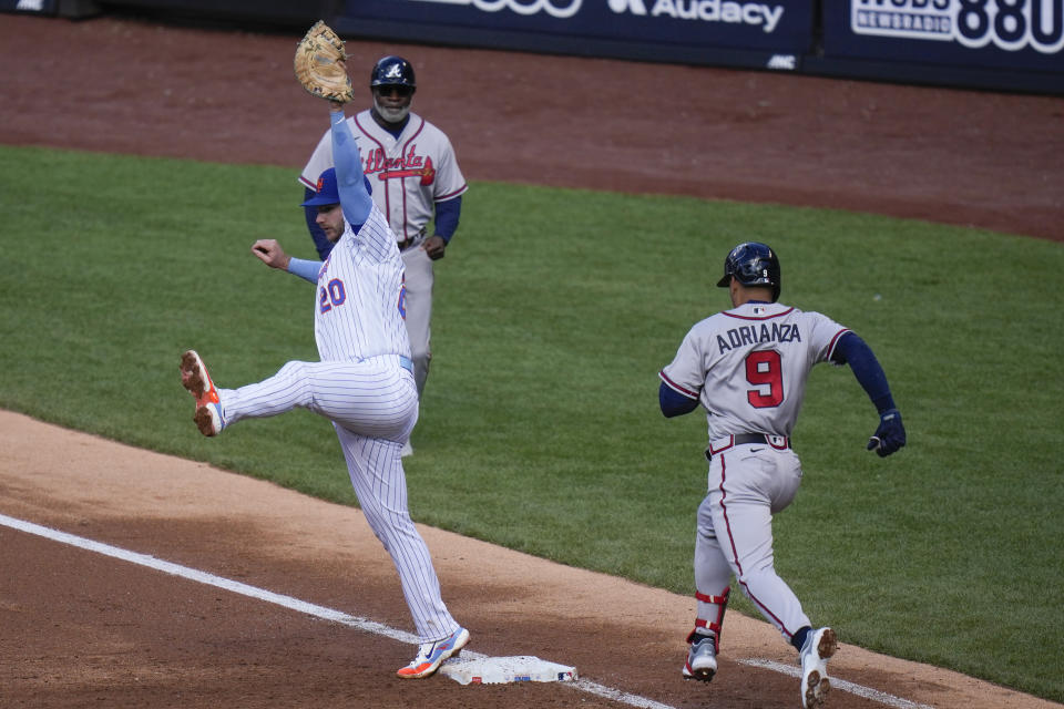 New York Mets first baseman Pete Alonso, left, makes a catch in time to get out Atlanta Braves' Ehire Adrianza (9) during the third inning of the second baseball game of a doubleheader at Citi Field, Monday, May 1, 2023, in New York. (AP Photo/Seth Wenig)