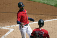 Minnesota Twins' Byron Buxton, left, scores on a two-run single by Minnesota Twins' Willians Astudillo in the third inning of a baseball game, Thursday, May 6, 2021, in Minneapolis. At right is Twins' Max Kepler. (AP Photo/Jim Mone)