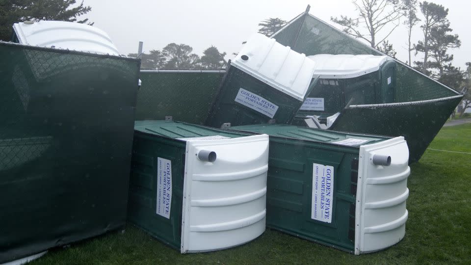 Fallen portable toilets at Pebble Beach on Sunday. - Ryan Sun/AP