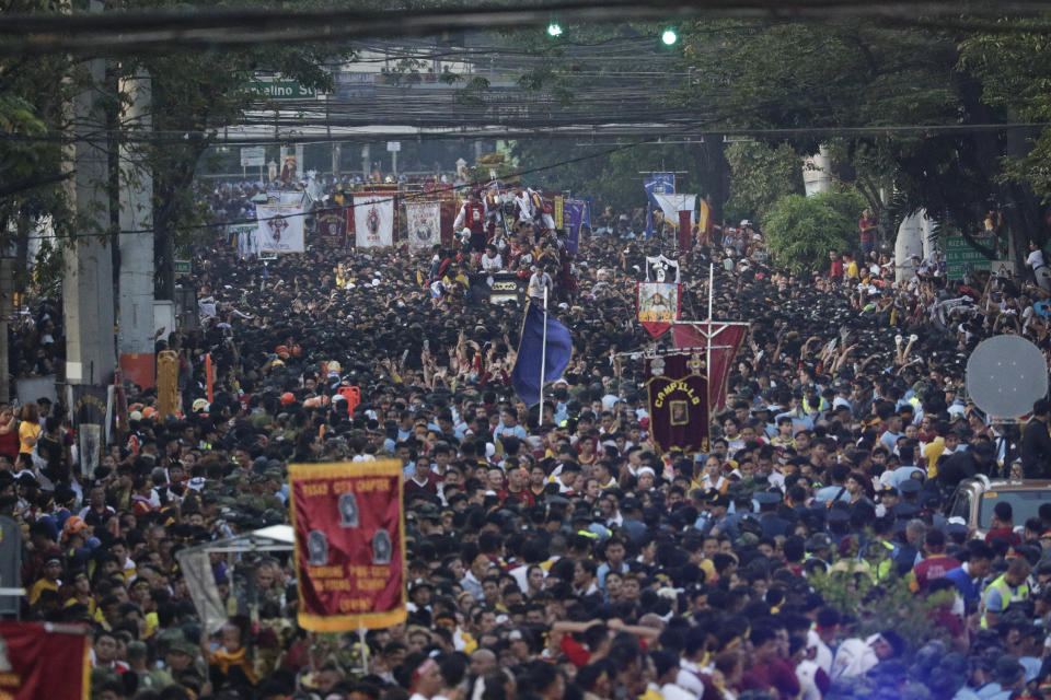 Devotees follow the carriage of the Black Nazarene during a raucous procession to celebrate its feast day Thursday, Jan. 9, 2020, in Manila, Philippines. A mammoth crowd of mostly barefoot Filipino Catholics prayed for peace in the increasingly volatile Middle East at the start Thursday of an annual procession of a centuries-old black statue of Jesus Christ in one of Asia's biggest religious events. (AP Photo/Aaron Favila)