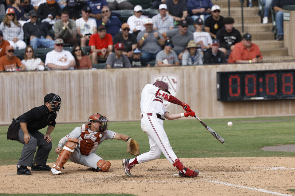 Stanford's Malcolm Moore, right, hits a home run against Texas in the seventh inning of an NCAA college baseball tournament super regional game in Stanford, Calif., Saturday, June 10, 2023. (AP Photo/Josie Lepe)