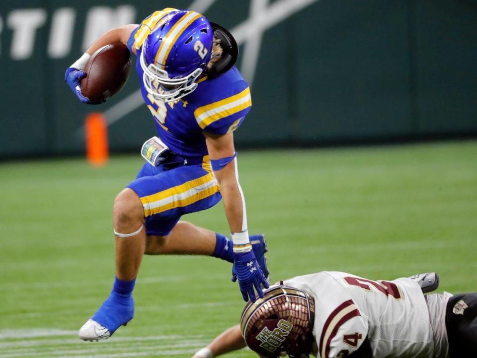 Brock running back Zachary Brewster (2) jumps Whitesboro linebacker/ wide receiver Jayce Sanders (24) for yards during a high school Class 3A Division 1 Quarterfinals playoff game at Globe Life Field in Arlington, Texas, Thursday, Dec. 02, 2021. Brock led 28-0 at the half. (Special to the Star-Telegram Bob Booth)