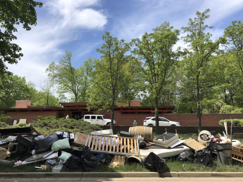 Piles of household debris line Valley Drive in Midland, Michigan, on Wednesday, May 27, 2020. The Central Michigan city, known for its midcentury modern architecture, was submerged after torrential rains overwhelmed two dams. Architecture enthusiasts worry how extensively the structures were damaged. (AP Photo/Tammy Webber)