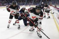 United States' Britta Curl (16) battles Canada's Jocelyne Larocque (3) and Marie-Philip Poulin (29) during the first period of a rivalry series women's hockey game in Hartford, Conn., Saturday, Dec. 14, 2019. (AP Photo/Michael Dwyer)