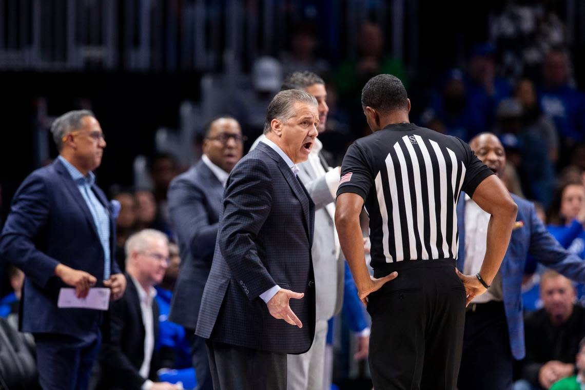 John Calipari talks with a referee during a game this season, with his assistant coaches, from left, Chuck Martin, John Welch, Chin Coleman, Orlando Antigua and Bruiser Flint in the background.