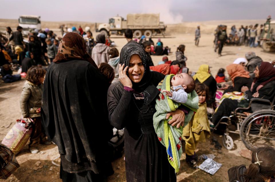 <p>A displaced Iraqi woman who just fled her home talks on the phone as Iraqi forces battle with Islamic State militants, in western Mosul, Iraq February 27, 2017. (Zohra Bensemra/Reuters) </p>