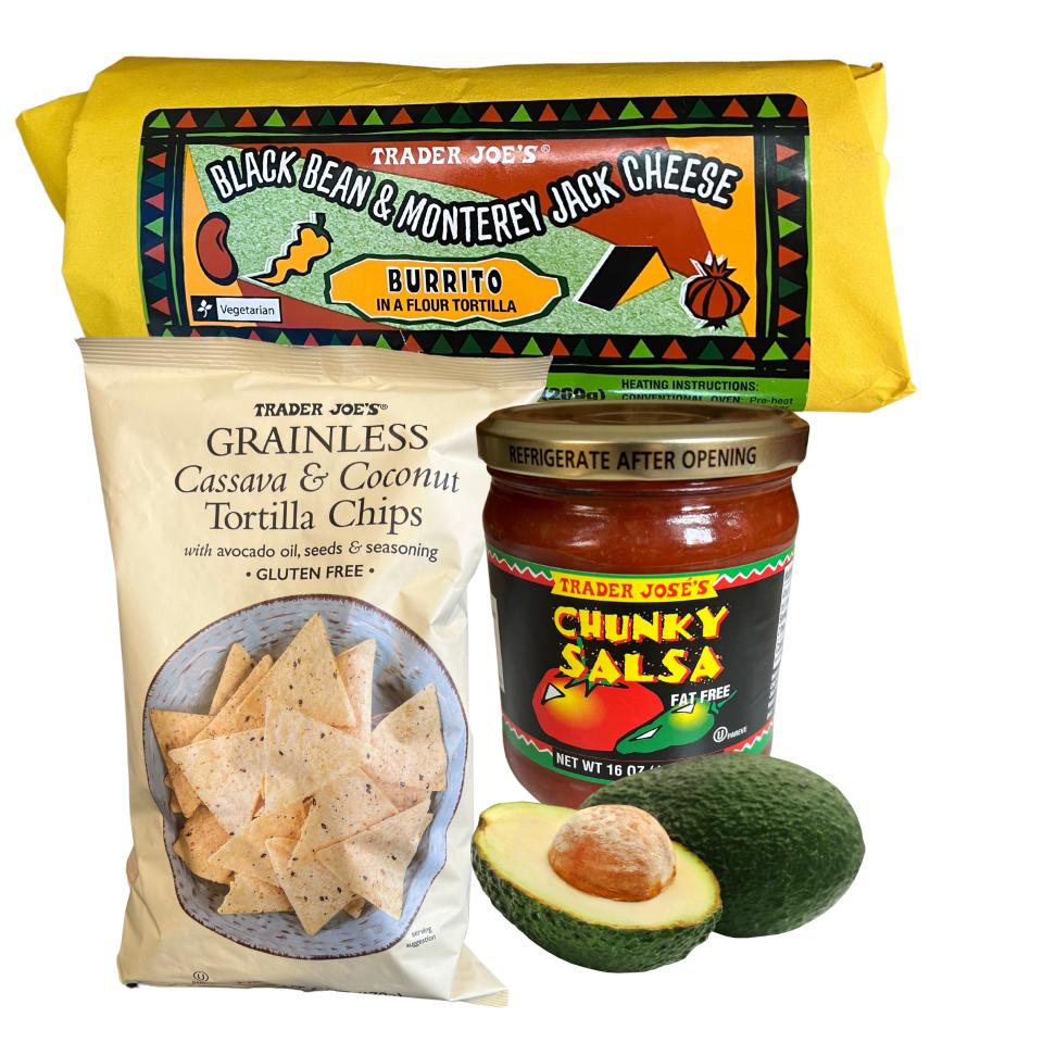 Packaged burritos in yellow wrapping, a bag of tortilla chips, a jar of chunky salsa, and a halved avocado