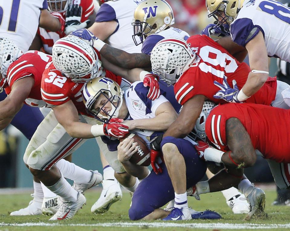 Jake Browning, here being sacked against Ohio State in the 2019 Rose Bowl, spent much of his time at Washington trying to improve his arm strength.