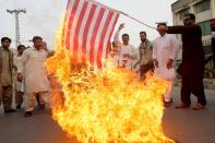 Pakistani demonstrators burn a US flag during a protest in Multan on May 24, 2016 against the US drone strike in Pakistan's southwestern province Balochistan