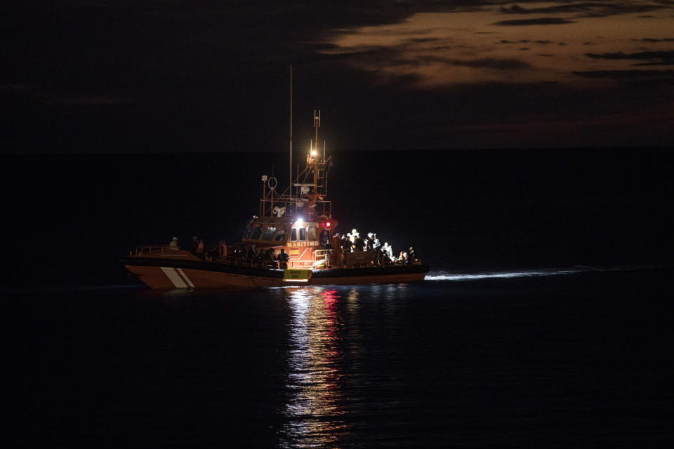 Spanish coastguards dock in Arguineguin carrying over 80 people after their rescue in Gran Canaria island, Spain on Tuesday, Nov. 24, 2020. Spanish rescue services said Wednesday at least seven people died after a migrant boat carrying more than 30 people hit rocks close to a small port on the Canary Island of Lanzarote. Many of the rescued were taken to the Arguineguín dock on the southwestern coast of Gran Canaria island, where several thousand people of different origin are being kept, some in tents. (AP Photo/Javier Fergo)