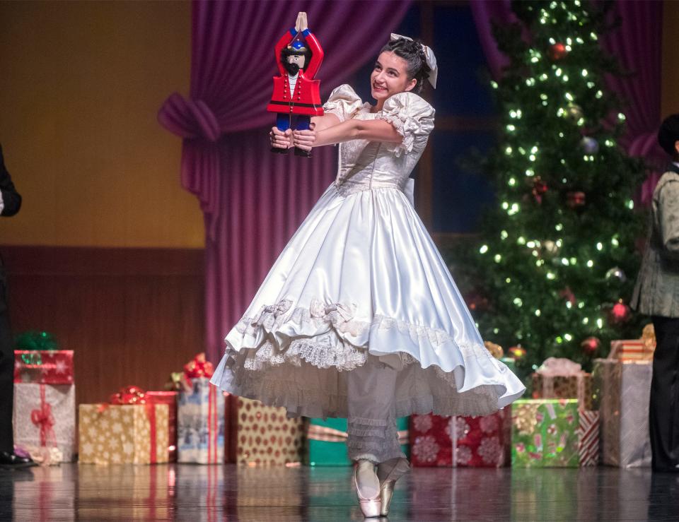 Hannah Swanson, portraying Clara, dances with her Christmas gift of a nutcracker in a scene from the Capitol Ballet Company production of The Nutcracker at San Joaquin Delta College's Atherton auditorium in Stockton. 