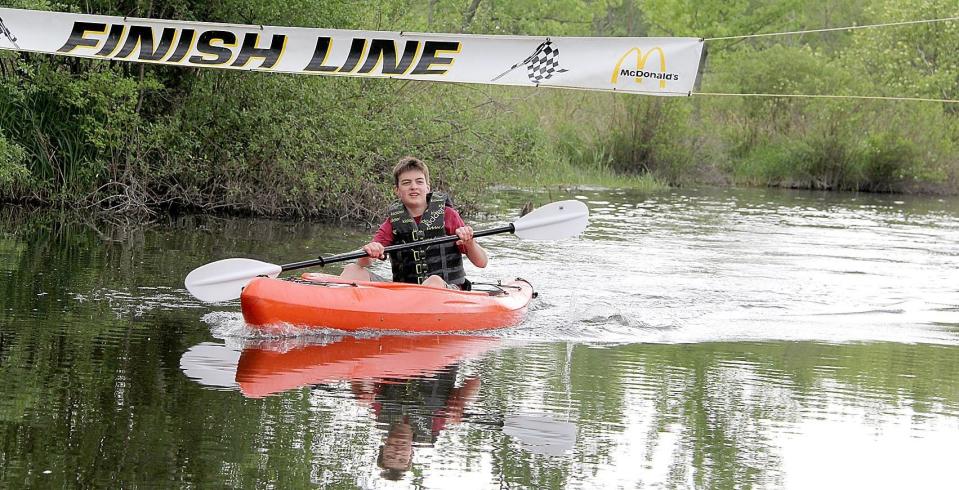 A participant in the river races crosses the finish line during a previous Riverfest event.