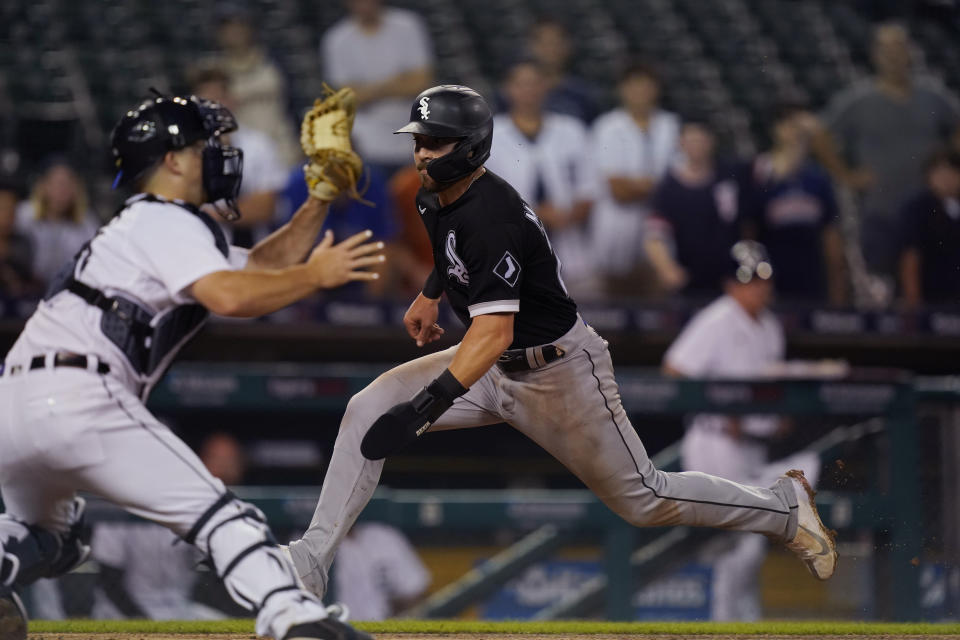 Chicago White Sox's Danny Mendick beats the throw to Detroit Tigers catcher Jake Rogers to score during the 10th inning of a baseball game, Friday, June 11, 2021, in Detroit. (AP Photo/Carlos Osorio)