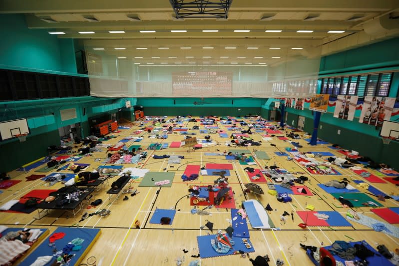 Anti-government demonstrators rest in a sports hall during protests at the Polytechnic University in Hong Kong