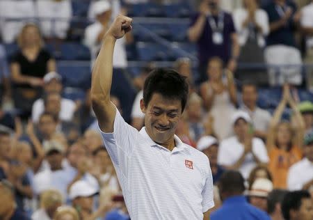 Kei Nishikori of Japan celebrates after defeating Stan Wawrinka of Switzerland in their quarter-final match at the 2014 U.S. Open tennis tournament in New York, September 3, 2014. REUTERS/Mike Segar