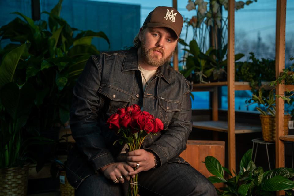 Country music artist Ernest Keith Smith, known as Ernest, poses at Flower Express in Nashville, Tenn., Monday, Jan. 23, 2023. Ernest has an upcoming deluxe album titled “Two Dozen Roses.”