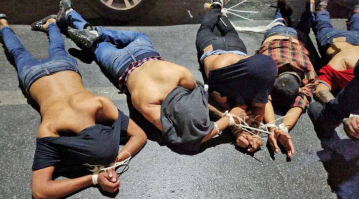 A photograph of five bound men facedown on the pavement accompanied a letter claiming to be from a Mexican drug cartel that included an apology after four Americans were abducted, two of whom died. (Obtained by NBC News)