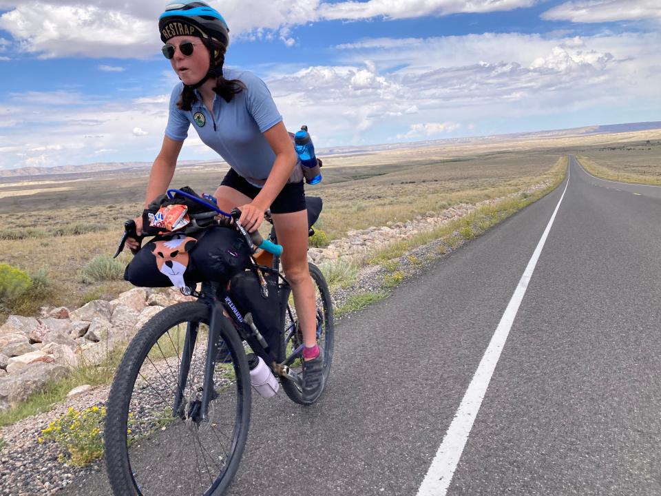 Scarlet Zeigler enjoys a stretch of pavement before another section of gravel during her 2,900-mile ride on the Continental Divide Trail.