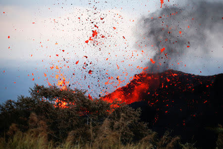 Lava erupts on the outskirts of Pahoa during ongoing eruptions of the Kilauea Volcano in Hawaii, U.S., May 19, 2018. REUTERS/Terray Sylvester