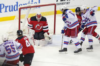 New Jersey Devils goaltender Mackenzie Blackwood (29) makes a save with multiple New York Rangers in front of the net during the second period of an NHL hockey game, Tuesday, April 13, 2021, in Newark, N.J. (AP Photo/Kathy Willens)