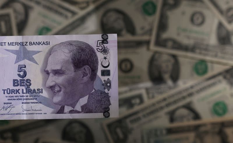 Turkish lira banknote is seen placed on U.S. Dollar banknotes in this illustration