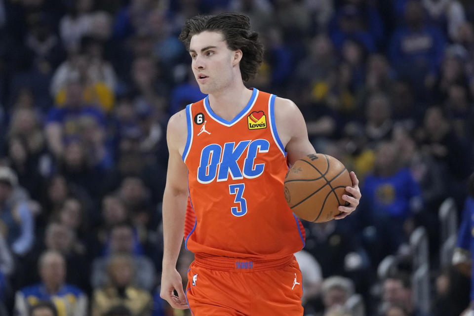 Oklahoma City Thunder guard Josh Giddey (3) brings the ball up the court against the Golden State Warriors during the first half of an NBA basketball game in San Francisco, Tuesday, April 4, 2023. (AP Photo/Jeff Chiu)