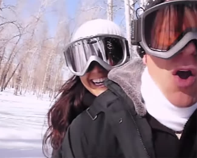 Bruce Willis and Emma Heming riding on a snowmobile