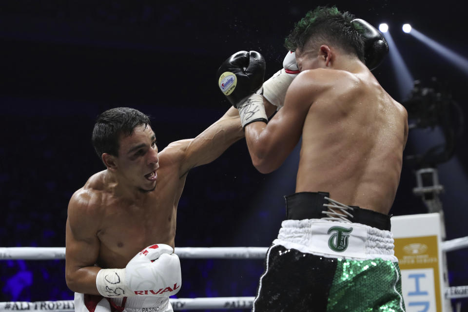 France's Nordine Oubaali, left, sends a left to Japan's Takuma Inoue in the seventh round of their WBC world bantamweight title match in Saitama, Japan, Thursday, Nov. 7, 2019. Oubaali defeated Inoue by a unanimous decision. (AP Photo/Toru Takahashi)